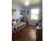 Bedroom with wood floors, built in shelving, and natural light at 2409 Victory Palm Dr, Edgewater, FL 32141