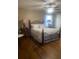 Bedroom features beautiful wood floors, white linens, and great natural lighting at 2409 Victory Palm Dr, Edgewater, FL 32141