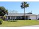 Charming single-story home featuring a well-maintained yard and a two-car garage at 2409 Victory Palm Dr, Edgewater, FL 32141