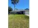 Charming one-story home featuring a beautifully landscaped front yard and a lush green lawn at 2409 Victory Palm Dr, Edgewater, FL 32141
