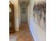 The hallway showcases neutral paint, lovely flooring and a large piece of decorative wall art at 2409 Victory Palm Dr, Edgewater, FL 32141