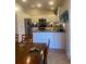 Bright kitchen with stainless appliances, granite counters, white cabinets, and a breakfast bar at 2409 Victory Palm Dr, Edgewater, FL 32141