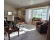 Comfortable living room with neutral walls, cozy seating, and light streaming through large windows at 2409 Victory Palm Dr, Edgewater, FL 32141