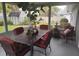 Enclosed patio featuring a table with red cushions, potted plants, and a water fountain for relaxing and comfortable outdoor dining at 2409 Victory Palm Dr, Edgewater, FL 32141