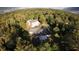 Aerial view of the property surrounded by lush greenery, showcasing the building's layout and expansive grounds at 2576 Shilo Glynn Ln, New Smyrna Beach, FL 32168