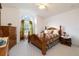 Charming bedroom featuring a wood bed frame, matching furnishings, and natural light from a large arched window at 2576 Shilo Glynn Ln, New Smyrna Beach, FL 32168