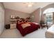 Cozy bedroom featuring a comfortable bed with decorative pillows and decoratively adorned display shelves at 2576 Shilo Glynn Ln, New Smyrna Beach, FL 32168