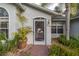 Inviting front entrance with decorative door and plants lining the textured walkway at 2576 Shilo Glynn Ln, New Smyrna Beach, FL 32168