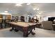 Spacious game room with a pool table, bar seating, and an open floor plan, perfect for entertaining at 2576 Shilo Glynn Ln, New Smyrna Beach, FL 32168