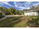 Spacious two-car garage with a well-manicured lawn and lush landscaping for added curb appeal at 2576 Shilo Glynn Ln, New Smyrna Beach, FL 32168