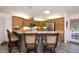 Inviting kitchen with wooden cabinets, stainless steel appliances, and breakfast bar seating at 2576 Shilo Glynn Ln, New Smyrna Beach, FL 32168