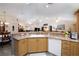 Bright kitchen with a large sink, light wood cabinets, and an open layout leading to the living area at 2576 Shilo Glynn Ln, New Smyrna Beach, FL 32168