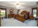 Cozy main bedroom showcasing an elegant wood bed frame, dresser, and soothing natural light at 2576 Shilo Glynn Ln, New Smyrna Beach, FL 32168