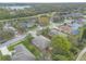 An aerial view shows community homes adjacent to the golf course and lake in a picturesque, relaxing neighborhood at 2626 Turnbull Estates Dr, New Smyrna Beach, FL 32168
