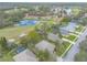 Aerial view of homes backing on a golf course and pond showing lush landscaping and mature trees at 2626 Turnbull Estates Dr, New Smyrna Beach, FL 32168