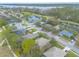 An aerial view shows community homes bordering the golf course, ponds, and a lake in a beautiful area at 2626 Turnbull Estates Dr, New Smyrna Beach, FL 32168