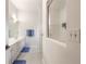 Bright bathroom featuring a sink, mirror, and stand-up shower with blue accents at 2626 Turnbull Estates Dr, New Smyrna Beach, FL 32168
