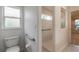 Bathroom with a toilet, grab bars, window and access to a stand-up shower at 2626 Turnbull Estates Dr, New Smyrna Beach, FL 32168