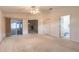 Large bedroom with sliding glass doors, and access to both an additional room and a bathroom at 2626 Turnbull Estates Dr, New Smyrna Beach, FL 32168
