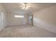 Neutral carpeted bedroom with natural lighting and a ceiling fan to keep you cool at 2626 Turnbull Estates Dr, New Smyrna Beach, FL 32168