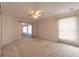 Bedroom with a ceiling fan, sliding glass doors, and access to a lanai at 2626 Turnbull Estates Dr, New Smyrna Beach, FL 32168