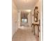 Elegant tiled entryway featuring a decorative mirror, console table, and views of the living area at 2626 Turnbull Estates Dr, New Smyrna Beach, FL 32168