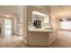 Open concept kitchen with breakfast bar, white cabinets, and easy access to dining area at 2626 Turnbull Estates Dr, New Smyrna Beach, FL 32168