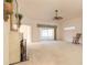 Spacious living room with fireplace, ceiling fan, and sliding glass doors to the lanai at 2626 Turnbull Estates Dr, New Smyrna Beach, FL 32168