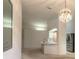 Open-concept living space with breakfast bar, modern appliances, and chandelier at 2626 Turnbull Estates Dr, New Smyrna Beach, FL 32168