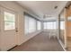 Bright sunroom with multiple windows, door to yard, sliding glass door, and ceiling fan at 2626 Turnbull Estates Dr, New Smyrna Beach, FL 32168