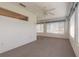 Spacious carpeted sunroom featuring windows with valances and a ceiling fan at 2626 Turnbull Estates Dr, New Smyrna Beach, FL 32168