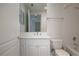 Bright bathroom featuring a white vanity, framed mirror, and shower-tub combo at 265 Minorca Beach Way # 505, New Smyrna Beach, FL 32169