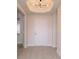 Bright entrance with modern lighting, a white door, and neutral-toned flooring at 265 Minorca Beach Way # 505, New Smyrna Beach, FL 32169
