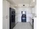 Well-lit kitchen boasts white cabinetry, black appliances, and a sleek, modern design at 265 Minorca Beach Way # 505, New Smyrna Beach, FL 32169