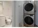 Efficient laundry area with stacked washer and dryer units near the bathroom at 265 Minorca Beach Way # 505, New Smyrna Beach, FL 32169