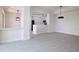 Open-concept living space with gray floors, kitchen view, and stylish lighting fixtures at 265 Minorca Beach Way # 505, New Smyrna Beach, FL 32169