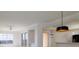 Bright living room with ceiling fan, modern lighting, and balcony access with stunning views at 265 Minorca Beach Way # 505, New Smyrna Beach, FL 32169