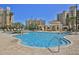 Resort-style pool area with comfortable lounge chairs and inviting clear blue water at 265 Minorca Beach Way # 505, New Smyrna Beach, FL 32169