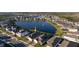 Stunning aerial view of a lakeside home in a well-planned community with a tranquil lake at 2820 Neverland Dr, New Smyrna Beach, FL 32168