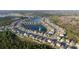 Aerial view of a community with a central lake, highlighting property location in a Gathering-friendly neighborhood at 2820 Neverland Dr, New Smyrna Beach, FL 32168
