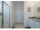 Bathroom featuring granite countertop, single vanity, tiled floors, and walk-in shower with glass door at 2820 Neverland Dr, New Smyrna Beach, FL 32168