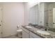 Bathroom features a double granite vanity, bright mirror, and a shower and tub with a tiled surround at 2820 Neverland Dr, New Smyrna Beach, FL 32168