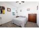 This bedroom has a neatly made bed, a window, and a wooden dresser, providing comfort and function at 2820 Neverland Dr, New Smyrna Beach, FL 32168
