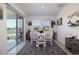 Cozy dining area with sliding glass doors, table, and a view of the lake at 2820 Neverland Dr, New Smyrna Beach, FL 32168