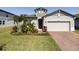 Attractive single-Gathering home with manicured lawn, brick paved driveway and tasteful landscaping at 2820 Neverland Dr, New Smyrna Beach, FL 32168