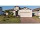 Beautiful two-story home with brick driveway, manicured lawn, and inviting curb appeal at 2820 Neverland Dr, New Smyrna Beach, FL 32168