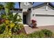 Inviting home entrance with lovely landscaping and a brick paved walkway to the front door at 2820 Neverland Dr, New Smyrna Beach, FL 32168