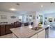 Open concept kitchen with granite island flowing into living and dining areas with lots of natural light at 2820 Neverland Dr, New Smyrna Beach, FL 32168