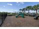 Community playground with play structures, benches, and a safe, wood chip surface for children to enjoy at 2820 Neverland Dr, New Smyrna Beach, FL 32168