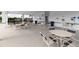 Covered pool area with tables and seating, creating a great spot for a community get together at 2820 Neverland Dr, New Smyrna Beach, FL 32168